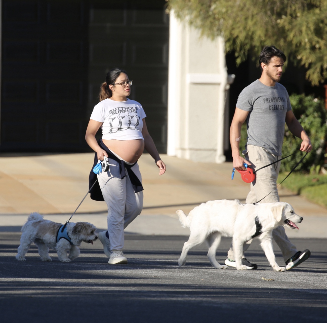 A very pregnant Gina Rodriguez walks with her husband, Joe Locicero, through the streets of Los Angeles